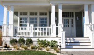 Pillared porches with double columns | h3 outdoor design & construction Elegant Pillared Porch Featuring Symmetrical Double Column Design for Added Curb Appeal